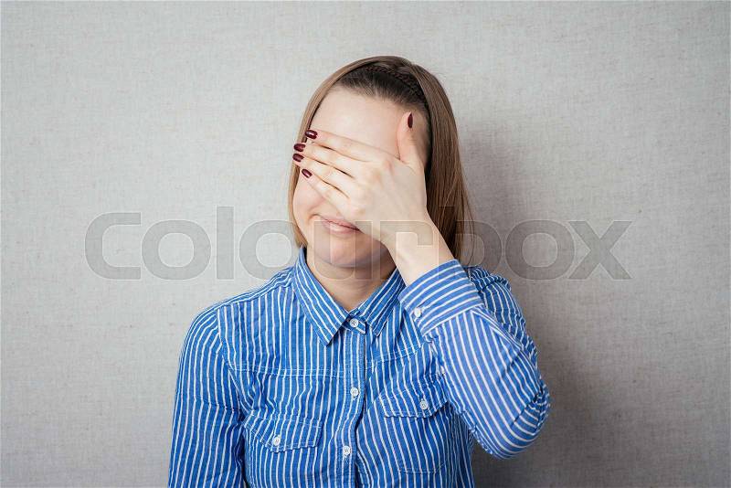 Young girl covering her eyes/ isolated, stock photo