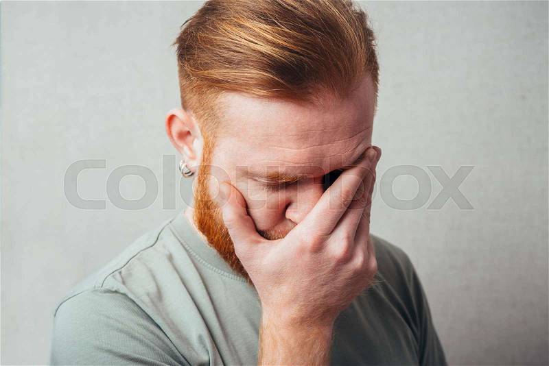 portrait of a Young red bearded Man feel bad, sad, stock photo