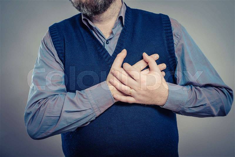 A young man suffering from heart pain, stock photo