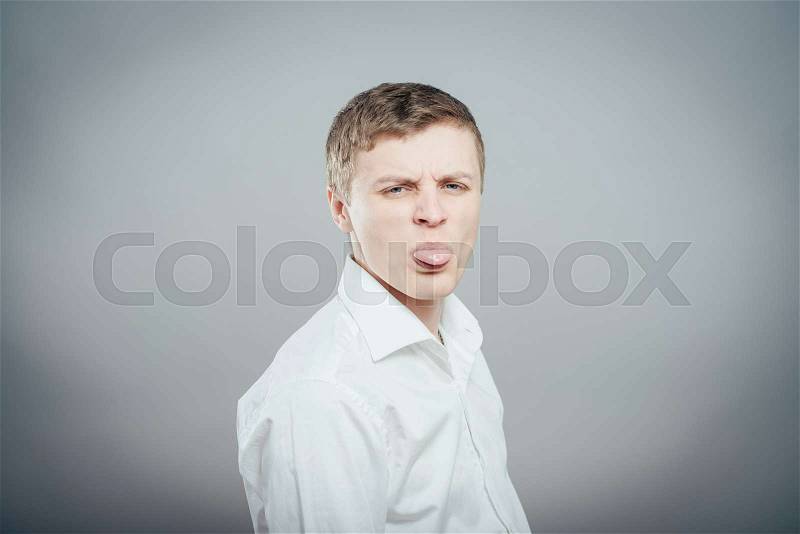 Adult man with bad manners - showing his tongue, stock photo