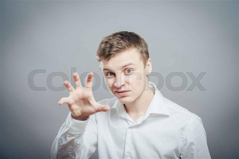 Young man trying to scare someone, stock photo