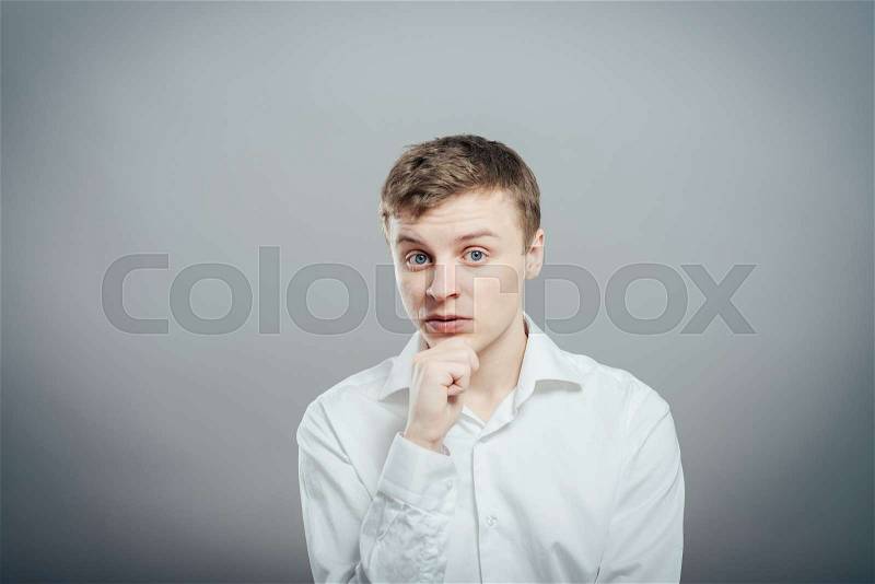 Young man thinks is interesting, stock photo