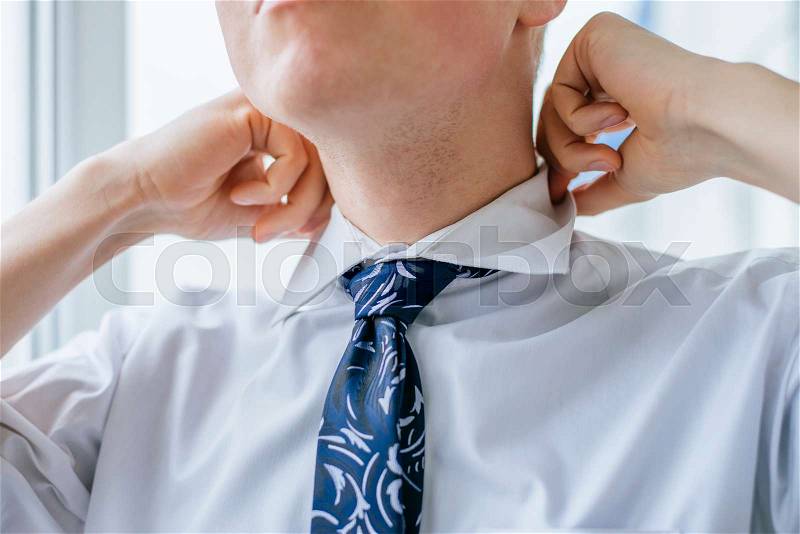 Young man tie a tie, stock photo