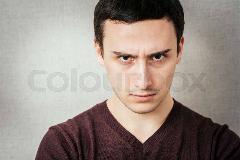 Portrait of disgusted man looking at the camera, stock photo