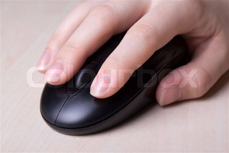 Close up of wireless mouse in female hand on table, stock photo