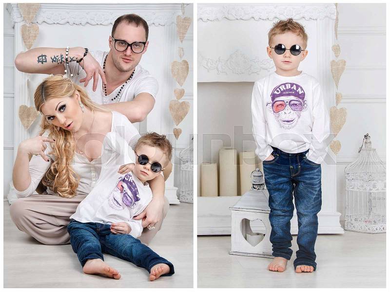 A happy stylish family with a child in white living room showing cool hand gesture, stock photo