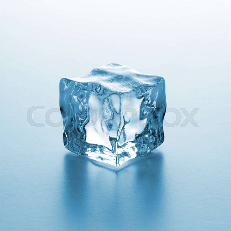 A ice cube on blue gradient background. Taken in Studio with a 5D mark III, stock photo