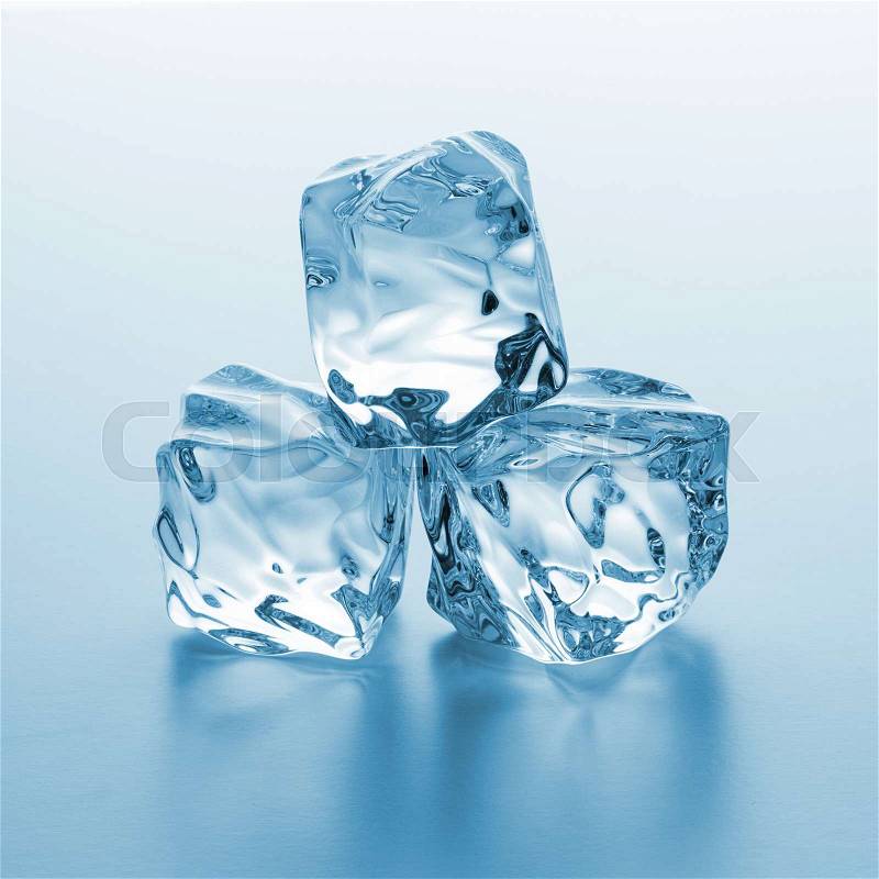 A pile of three ice cubes on blue gradient background. Taken in Studio with a 5D mark III, stock photo