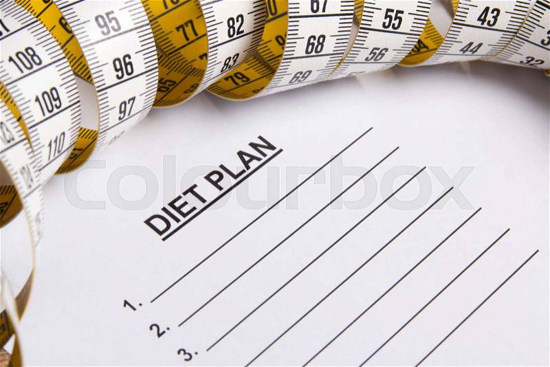 Close up of paper with diet plan and yellow measure tape, stock photo