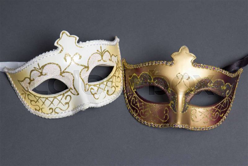 Two beautiful carnival masks on grey background, stock photo