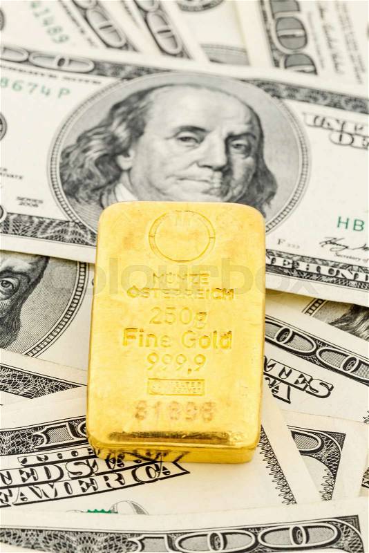 Gold bullion on dollar bills, symbolic photo for gold reserves, foreign exchange rates, investment, security, stock photo