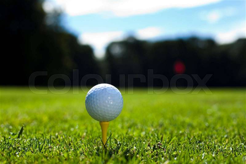 Girl playing golf on grass in summer, stock photo