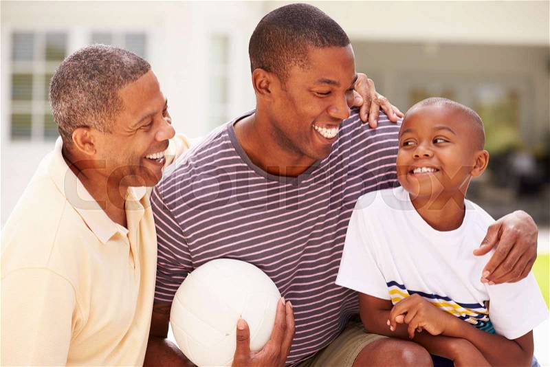 Grandfather With Son And Grandson Playing Volleyball, stock photo