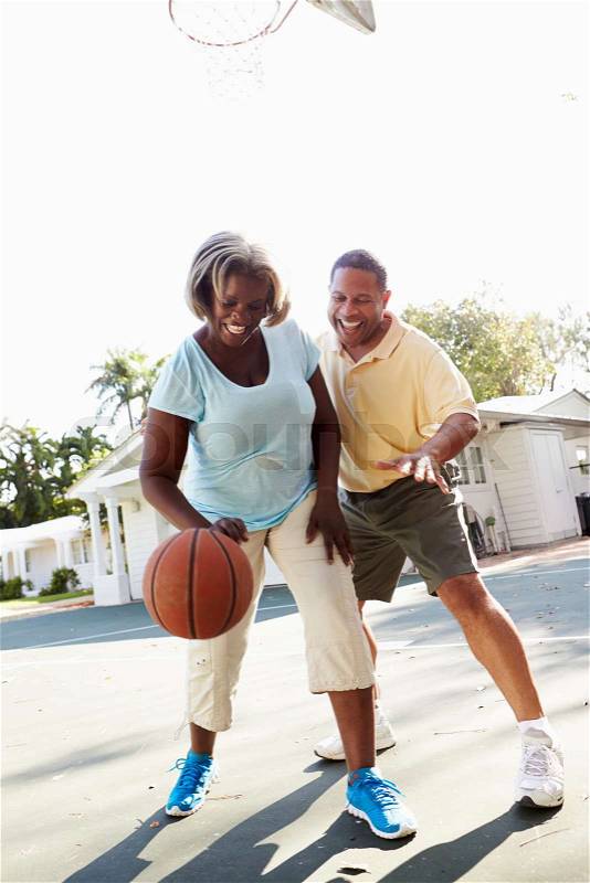 Senior Couple Playing Basketball Together, stock photo
