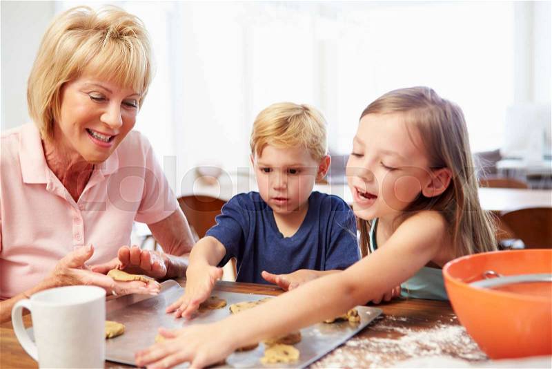 Grandmother And Grandchildren Baking Cookies Together, stock photo