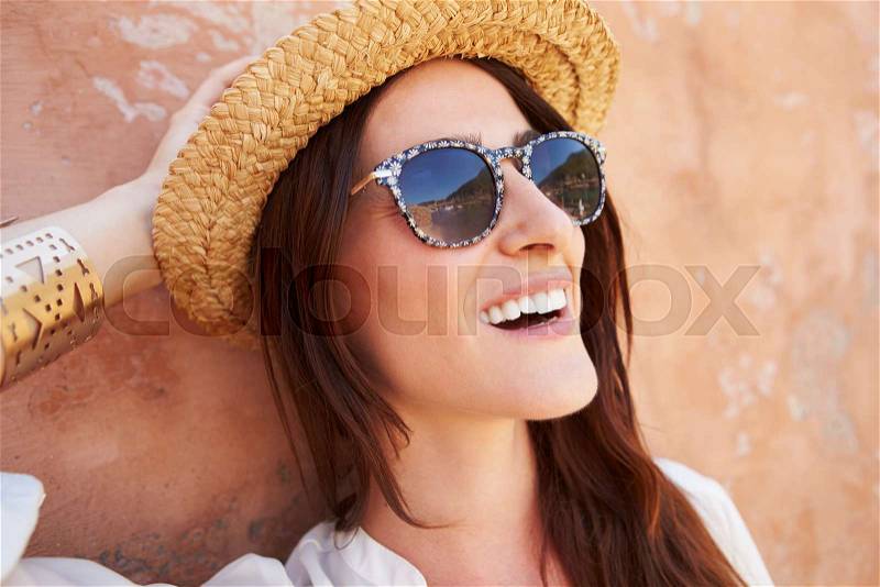 Head And Shoulders Portrait Of Pretty Woman Against Wall, stock photo