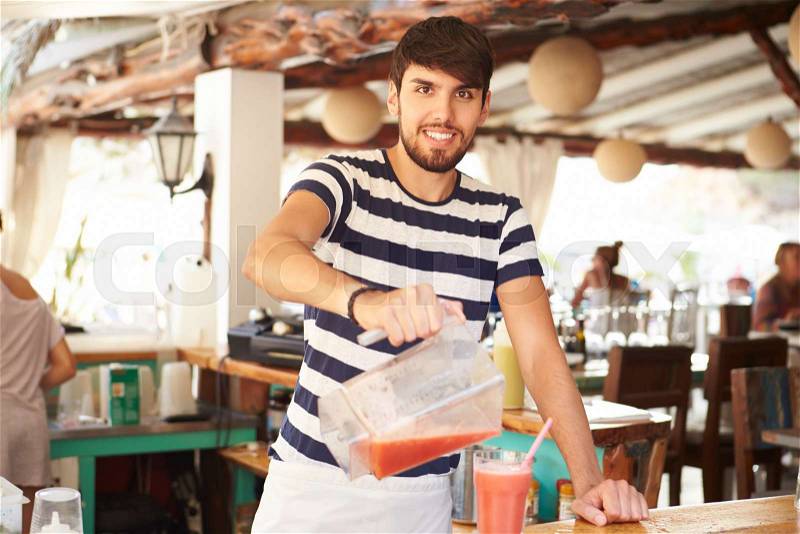 Portrait Of Man In Restaurant Making Fruit Smoothies, stock photo
