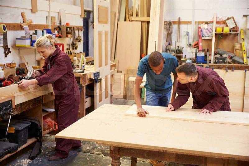 Staff Working In Busy Carpentry Workshop, stock photo