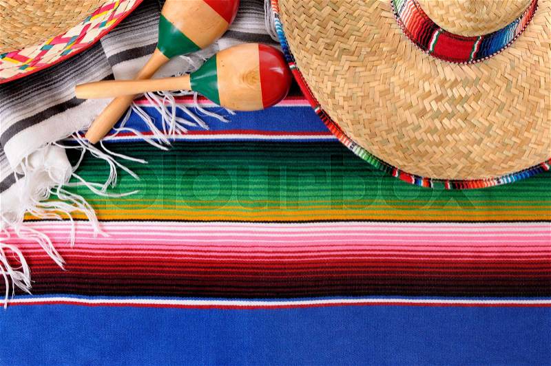 Mexican background with sombrero straw hat, maracas and traditional serape blanket or rug. Space for copy, stock photo