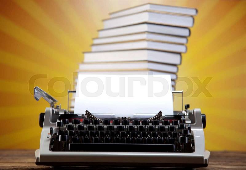 Vintage typewriter on old book, stock photo