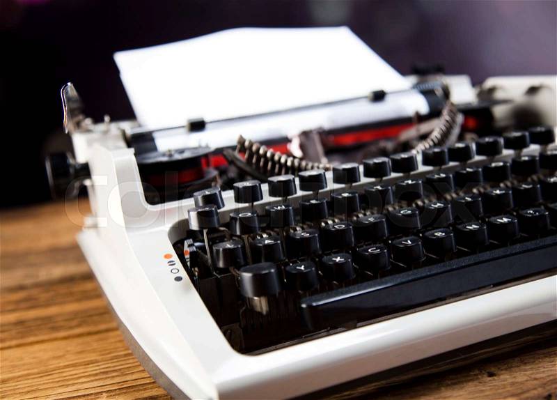 Retro typewriter with white paper, stock photo
