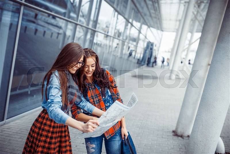 Two girlfriends looking for a route map.Art processing and retouching photos special, stock photo