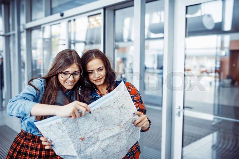 Two girlfriends looking for a route map.Art processing and retouching photos special, stock photo