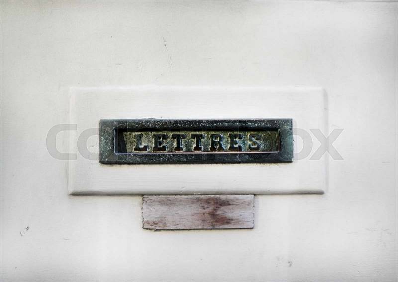 Vintage mail slot in a white door in Belgium, stock photo