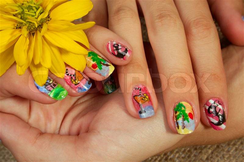 Drawing on nails of unusual figures gives to the woman originality, stock photo