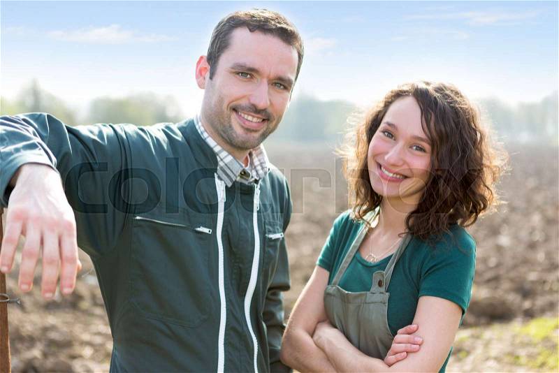 VIew of a Farmer team at work in a field, stock photo
