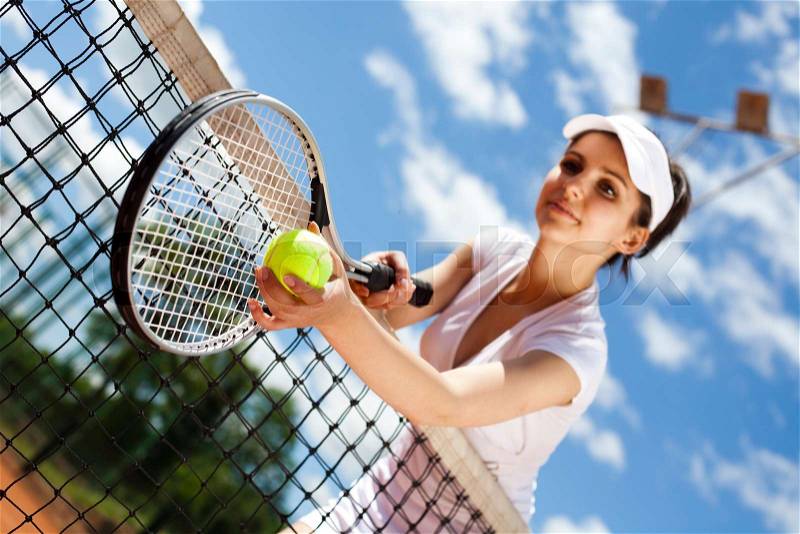 Young woman playing tennis, natural colorful tone, stock photo