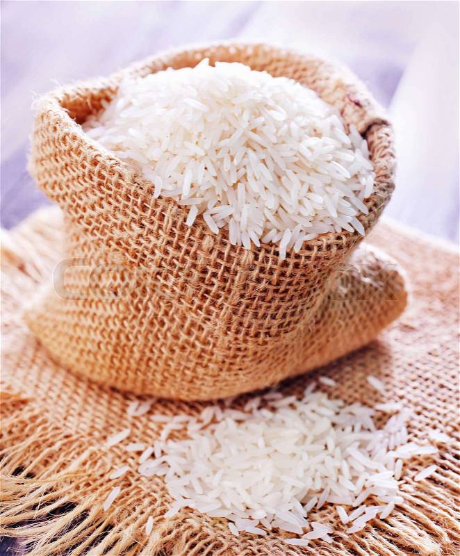 Raw rice in bag and on a table, stock photo