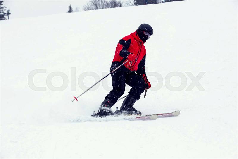 Male skier on downhill a steep hill, stock photo