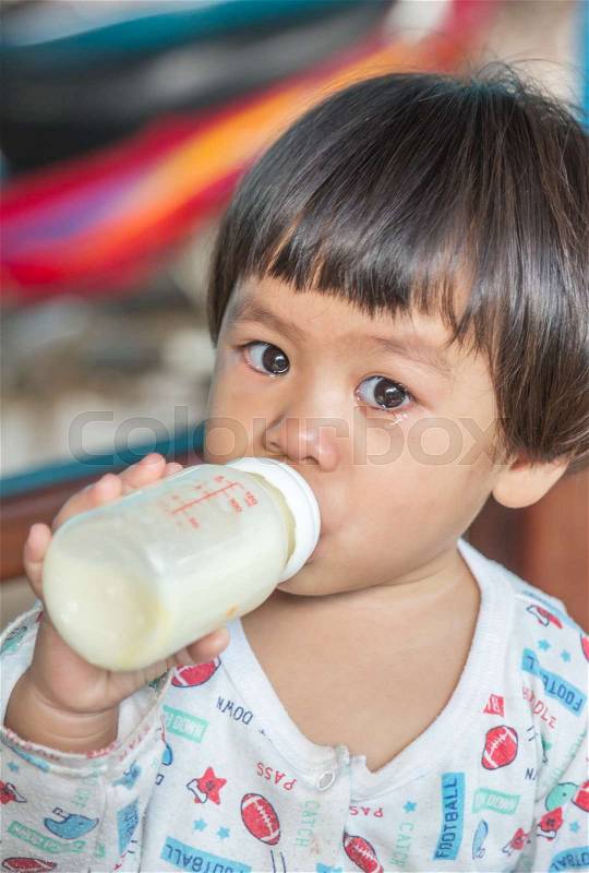 Baby feeding bottle by sobbing, stock photo