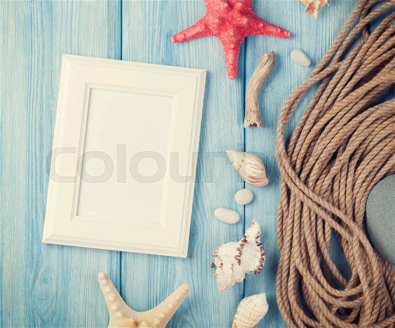 Summer time sea vacation with blank photo frame, star fish and marine rope. Retro toned, stock photo