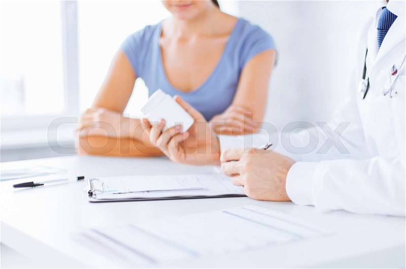 Close up of patient and doctor prescribing medication, stock photo