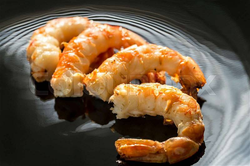 Fried shrimps on the black background, stock photo