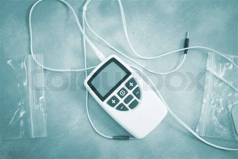 Electro physiotherapy electrical impulse stimulation rehabiliation treatment from injury equipment in hospital clinic for electrical stimulus attached with plaster. , stock photo