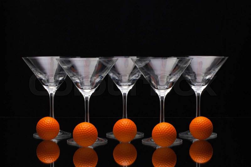 Five glasses of champagne with golf balls, stock photo