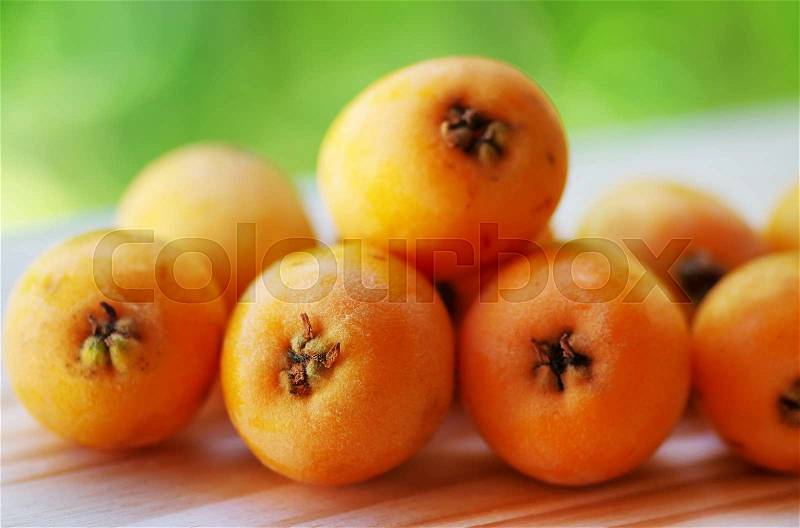 Nispero, Japanese medlar fruit, on table, stock photo