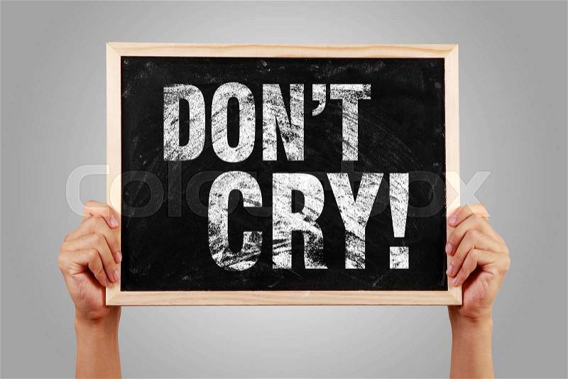 Do Not Cry blackboard is holden by hands with gray background, stock photo