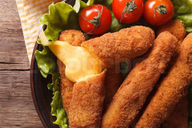 Hot fried cheese on a plate close-up, horizontal view from above , stock photo