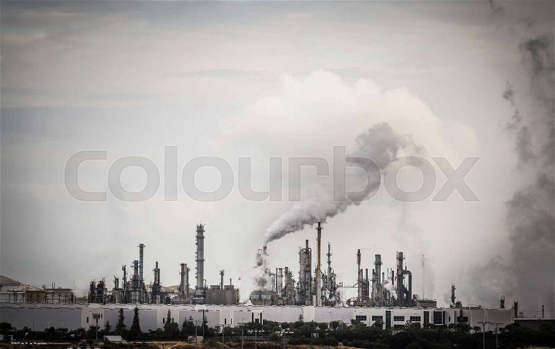 Working Industrial Plant with Smoke Stacks Billowing Smoke Into The Air, stock photo