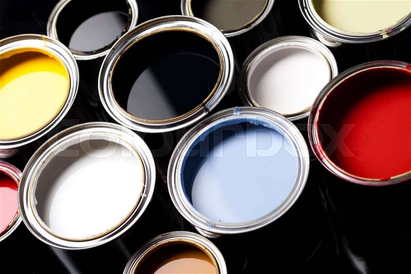 Cans of paint with paintbrush, stock photo