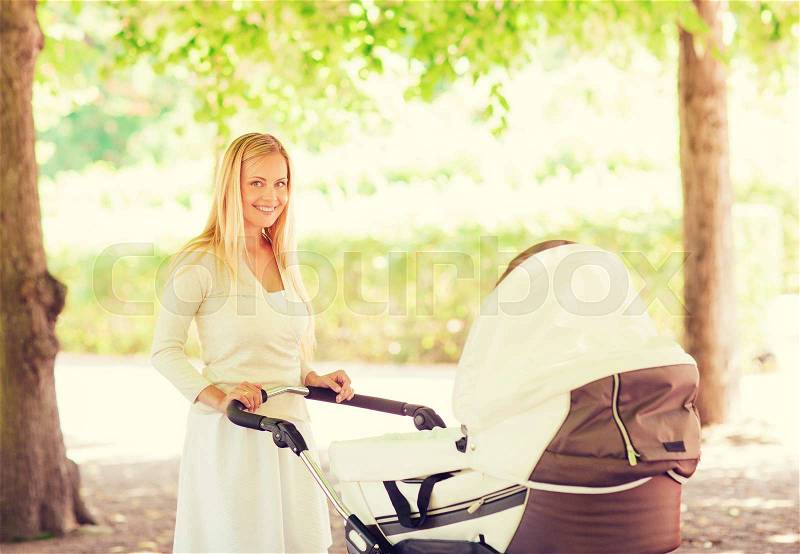 Family, child and parenthood concept - happy mother with stroller in park, stock photo