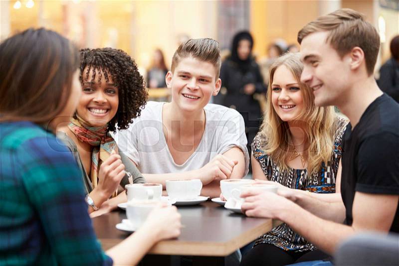 Group Of Young Friends Meeting In Café, stock photo