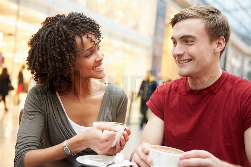 Young Couple Meeting On Date In Café, stock photo