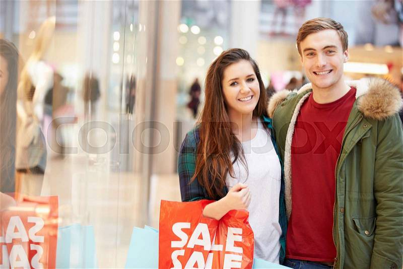 Happy Couple Carrying Bags In Shopping Mall, stock photo