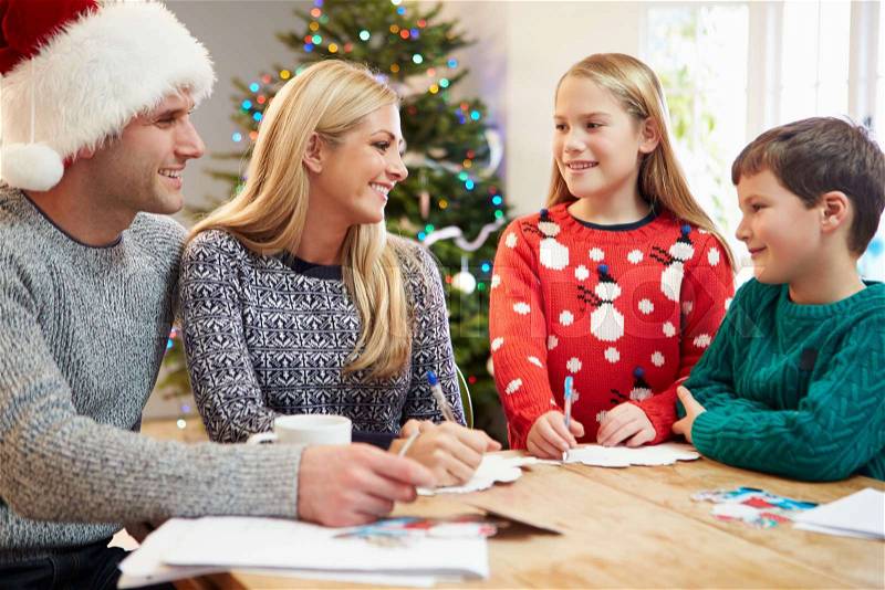 Family Writing Christmas Cards Together, stock photo