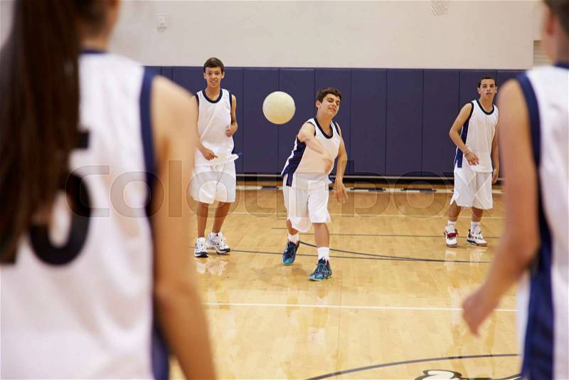High School Students Playing Dodge Ball In Gym, stock photo